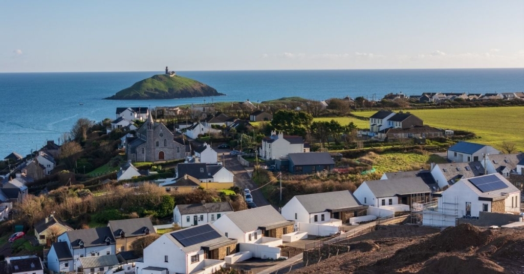 Overlooking the Ocean Drive development with modern residences, and panoramic sea views at sunset.